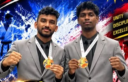 Two Perak Legends coaches holding their gold medals