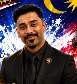 Perak Legends coach smiling in a black suit